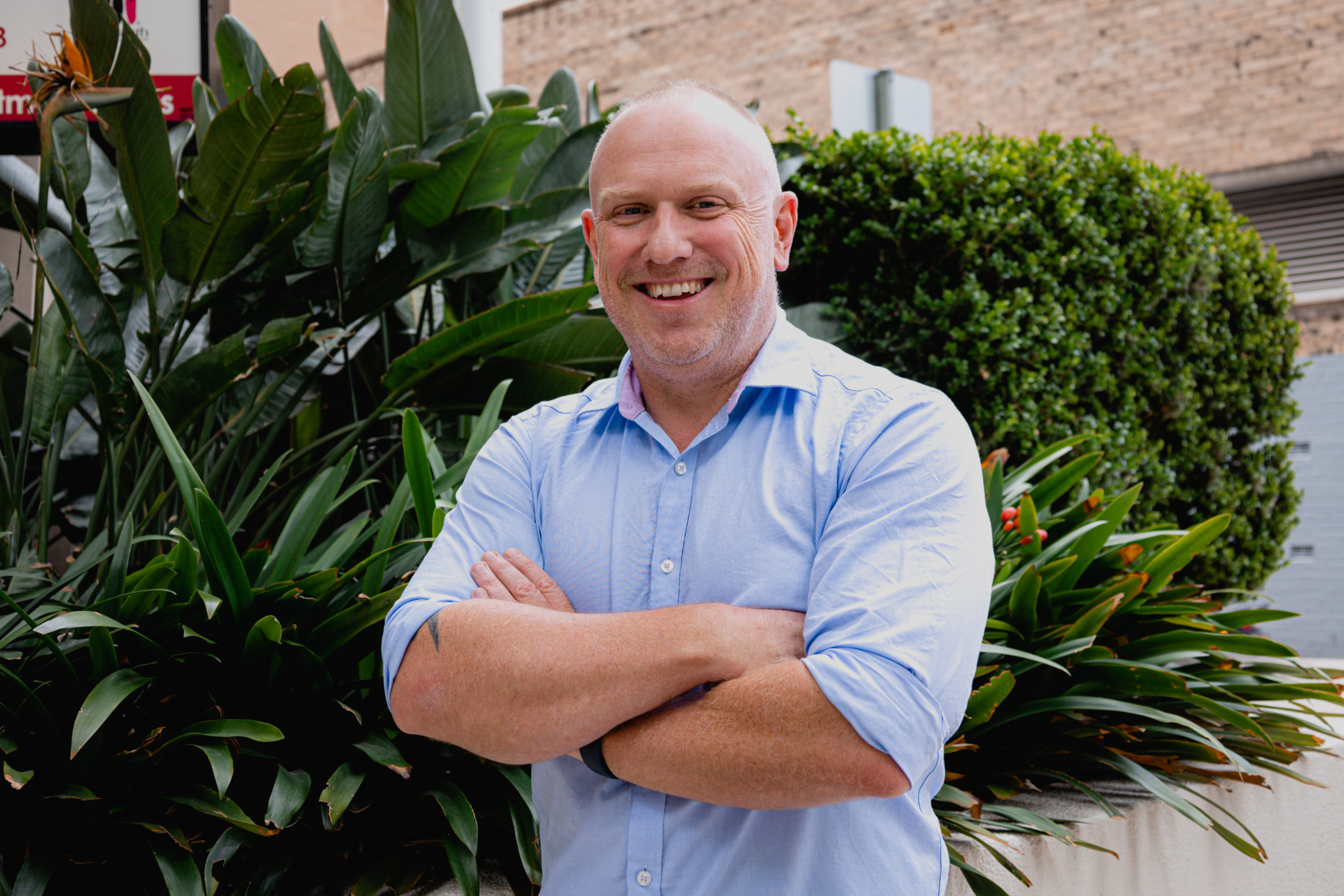 a corporate headshot portrait of civil structural design man engineer daniel taylor in front of trees