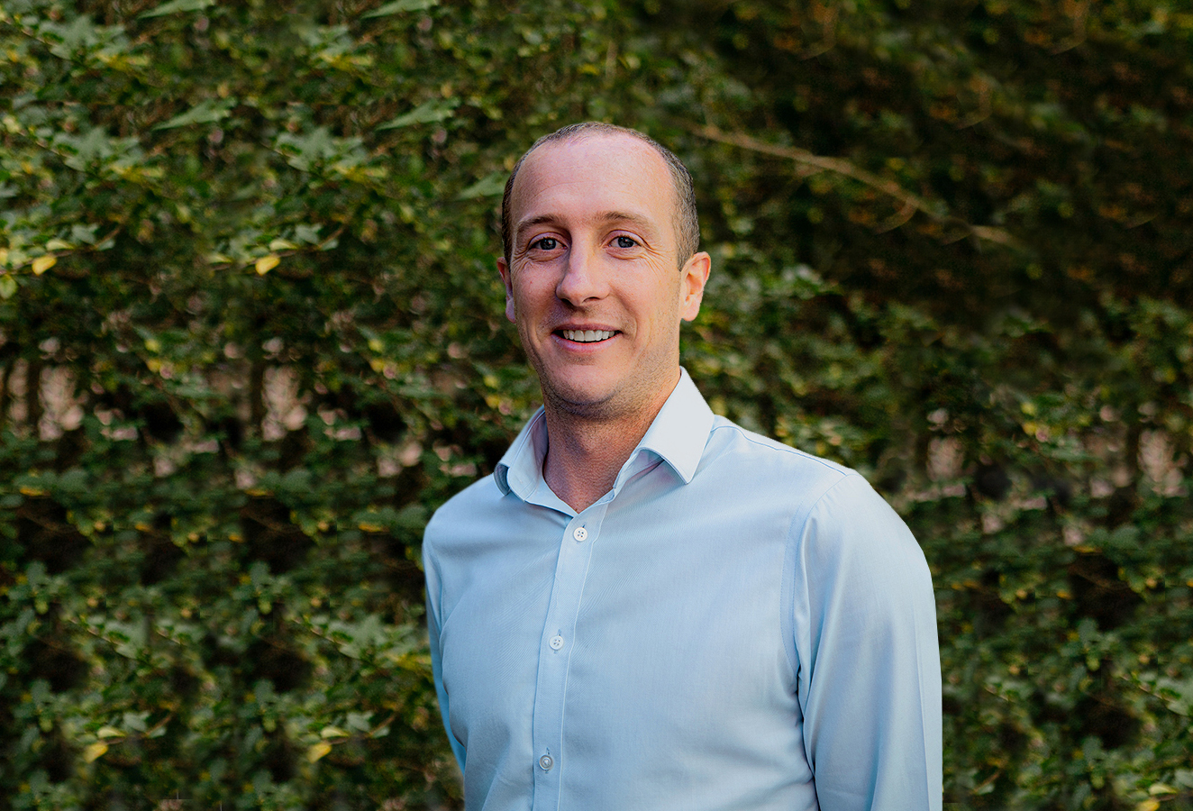 a corporate headshot portrait of civil structural design man engineer anthony mclellan in front of trees