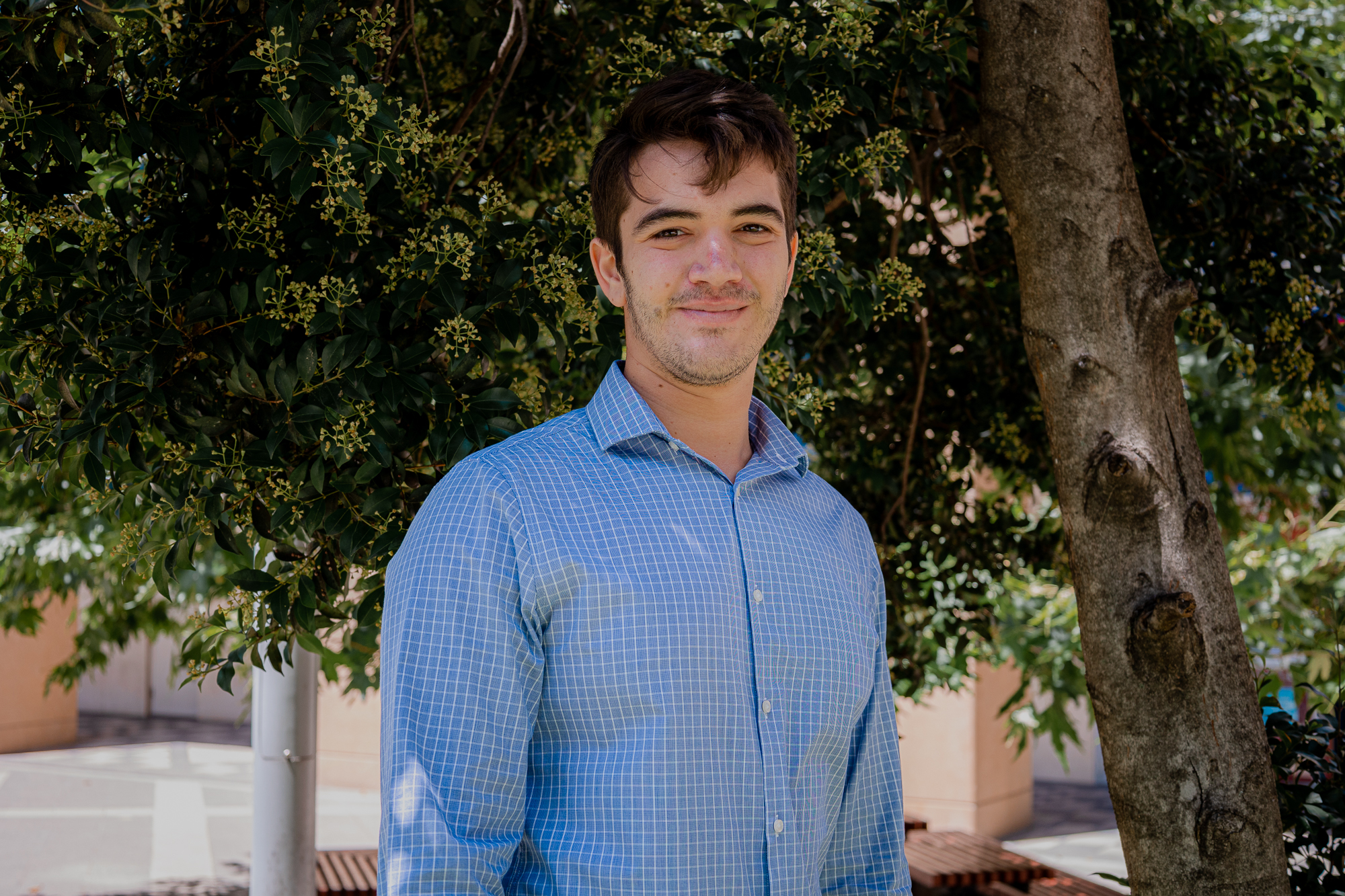 a corporate headshot portrait of civil structural design man engineer george dalianas in front of trees