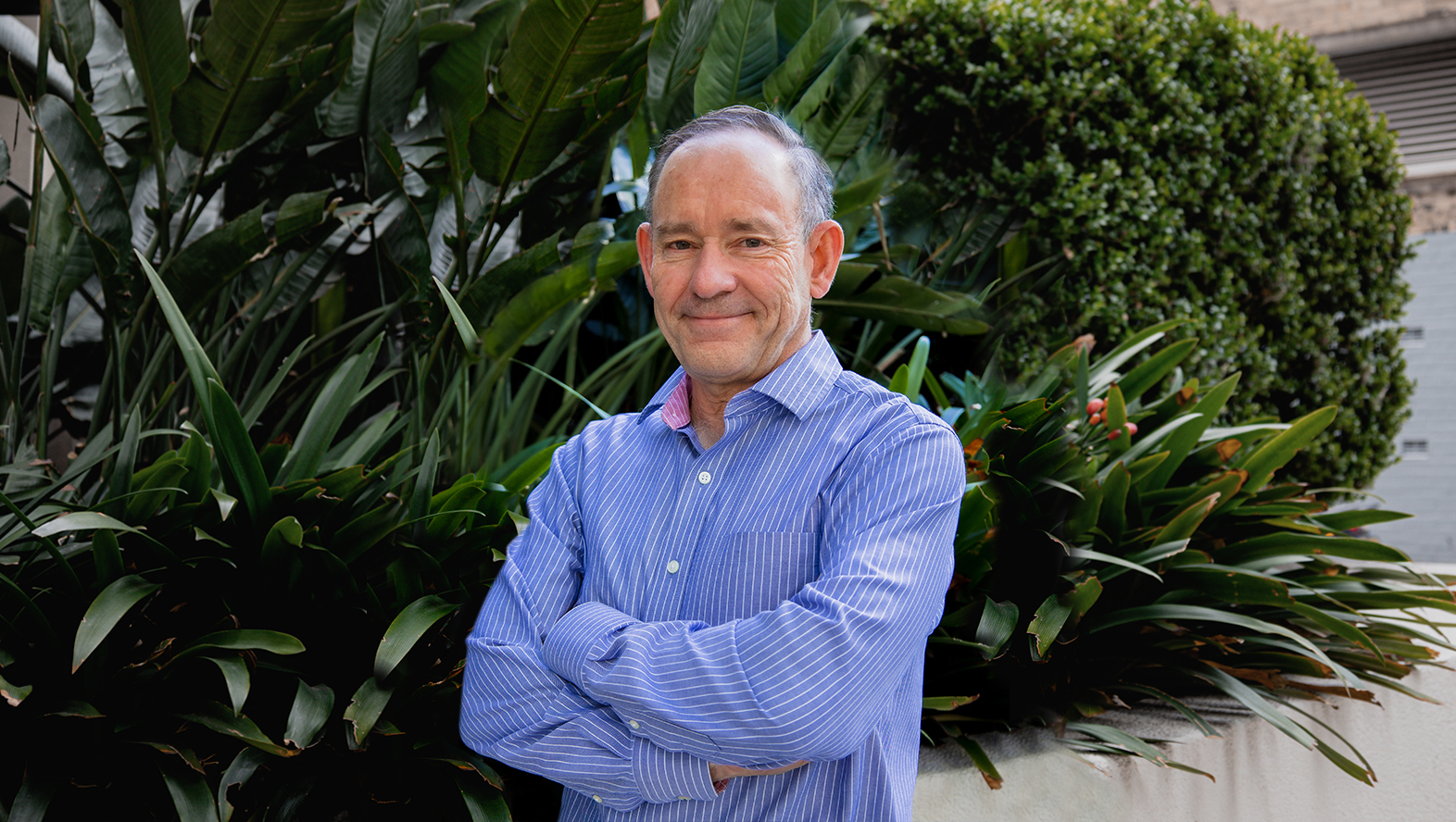 a corporate headshot portrait of civil structural design man engineer robert koch in front of trees