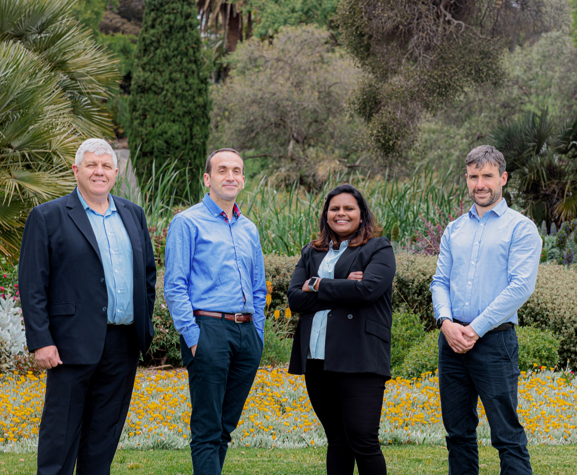 team photo of diverse female and male civil engineers at the park